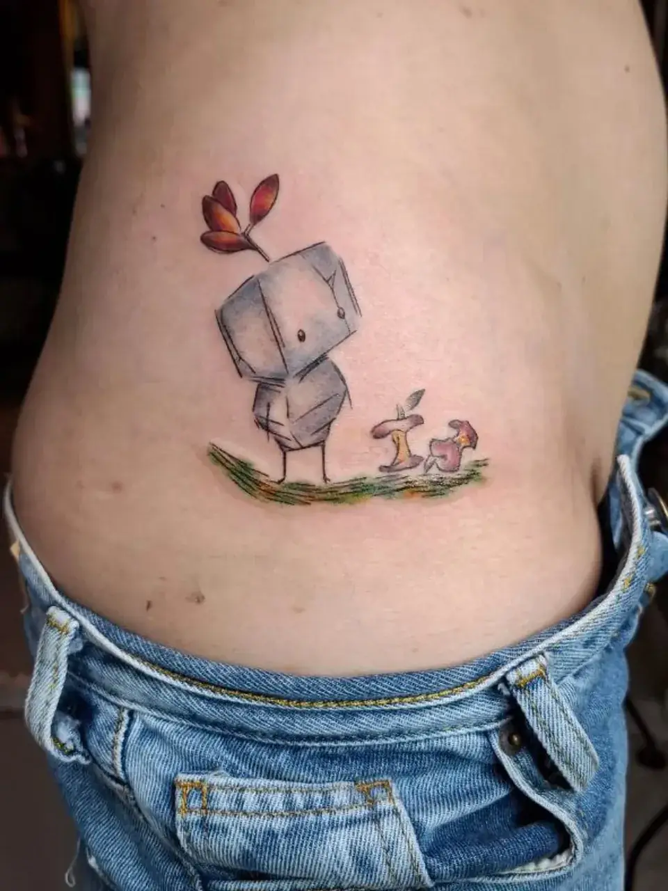 Tatuaje a color de un robot de piedra con una mariposa y hongos, en la cadera, por Jenn Tatts